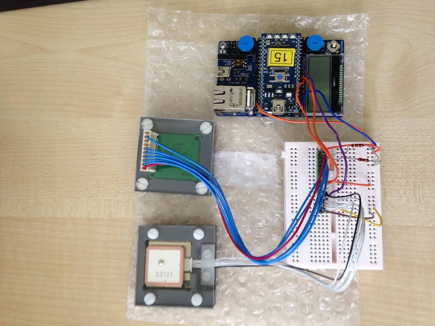 Prototype hardware: GPS module, compass board, breadboard and mbed microcontroller, wired together.